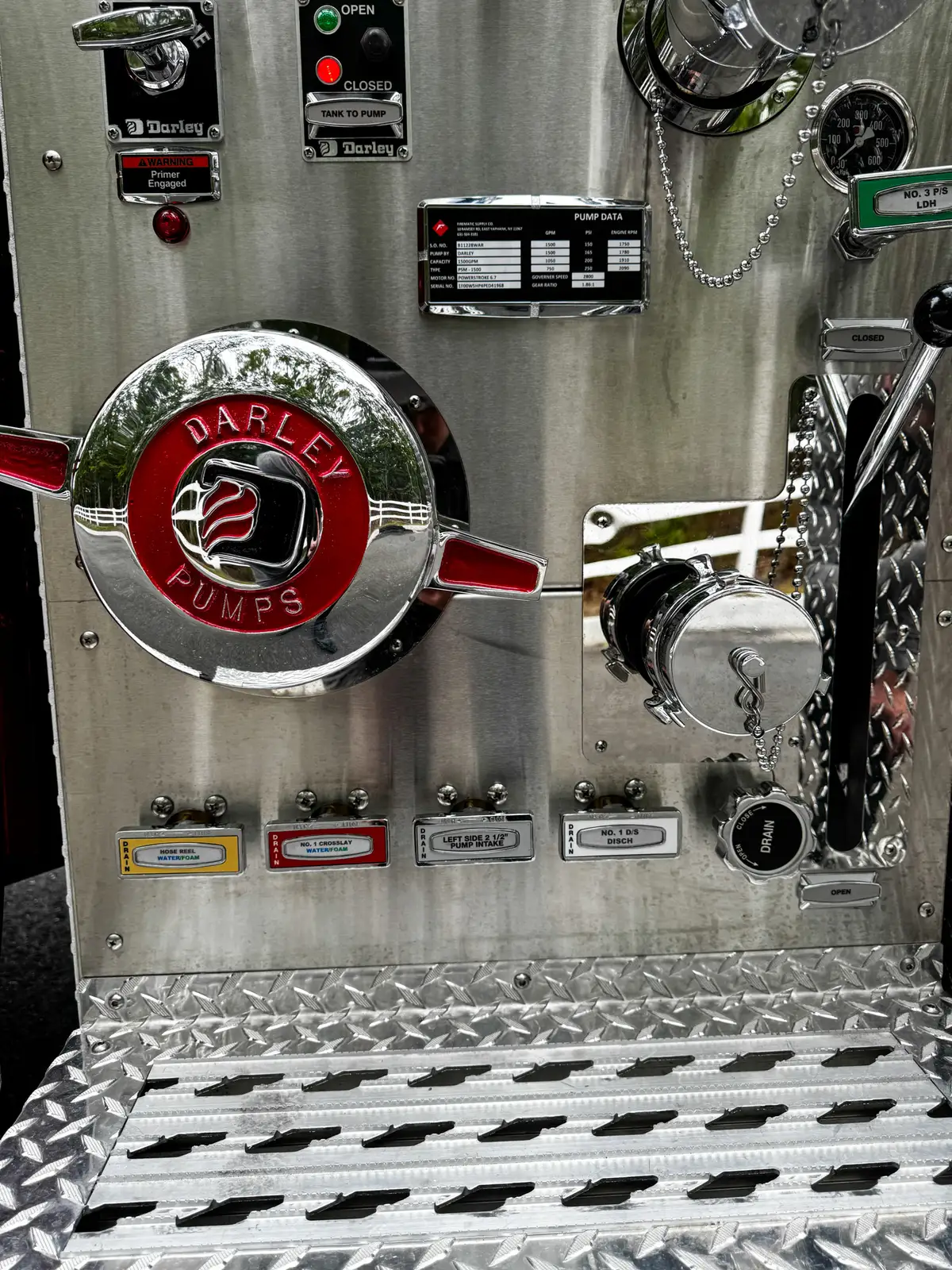 Open lower side service compartment showing wiring and pump-system components.